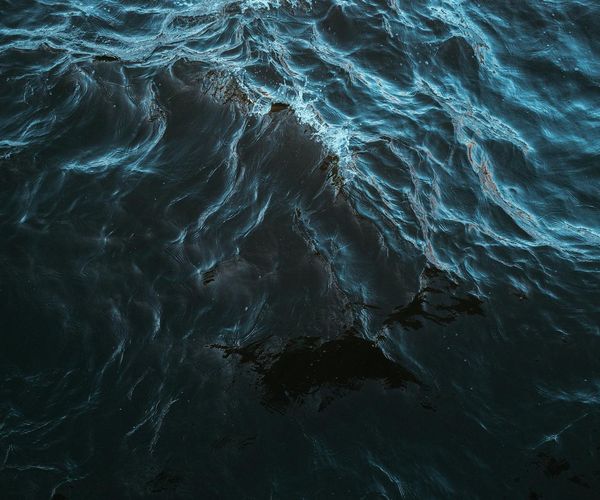 Flowing abstract lines representing energy and vitality in deep blue